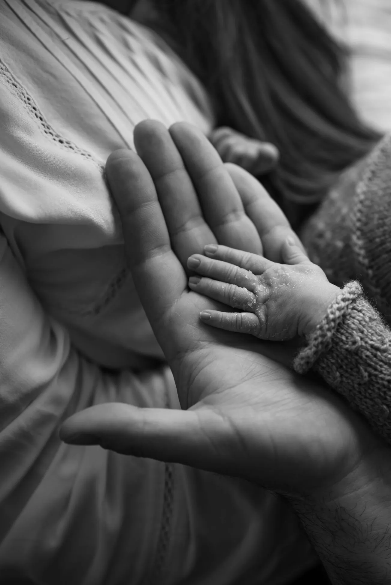 A parent holding a young child’s hand